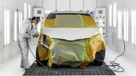 Collision Center Technician Painting a Vehicle | Findlay Toyota Prescott in Prescott AZ